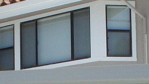 A bay of medium-sized house windows