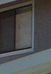 A small window on the upper floor of a house